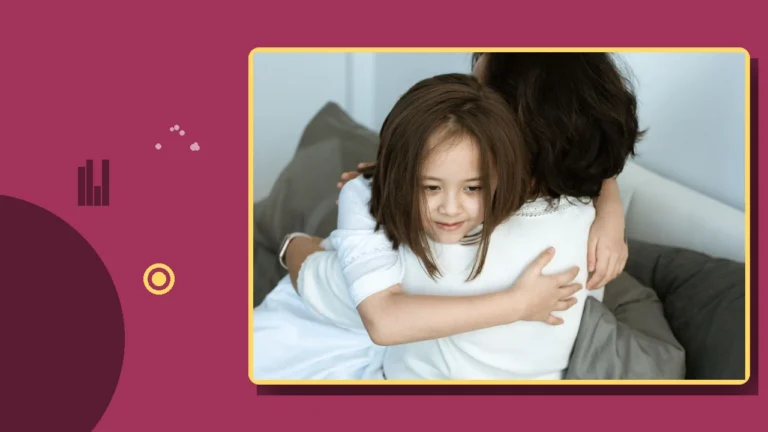 A child embracing a parent on a sofa at home.