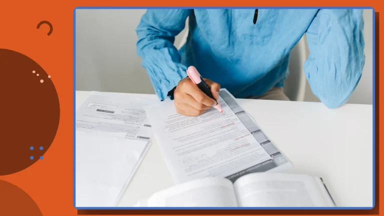 A person filling out legal forms at a desk with a book open beside them.