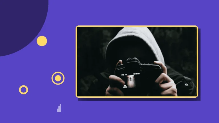 A hooded figure aiming a camera, illustrating the surveillance and monitoring tactics of coercive control.